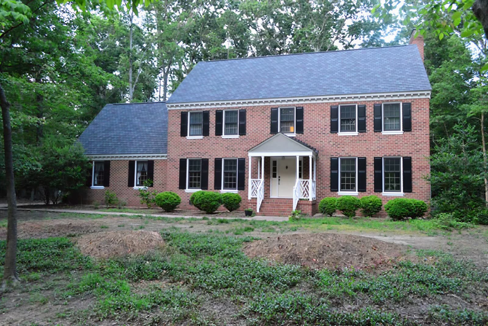 Your photo: Brick colonial on a wooded lot