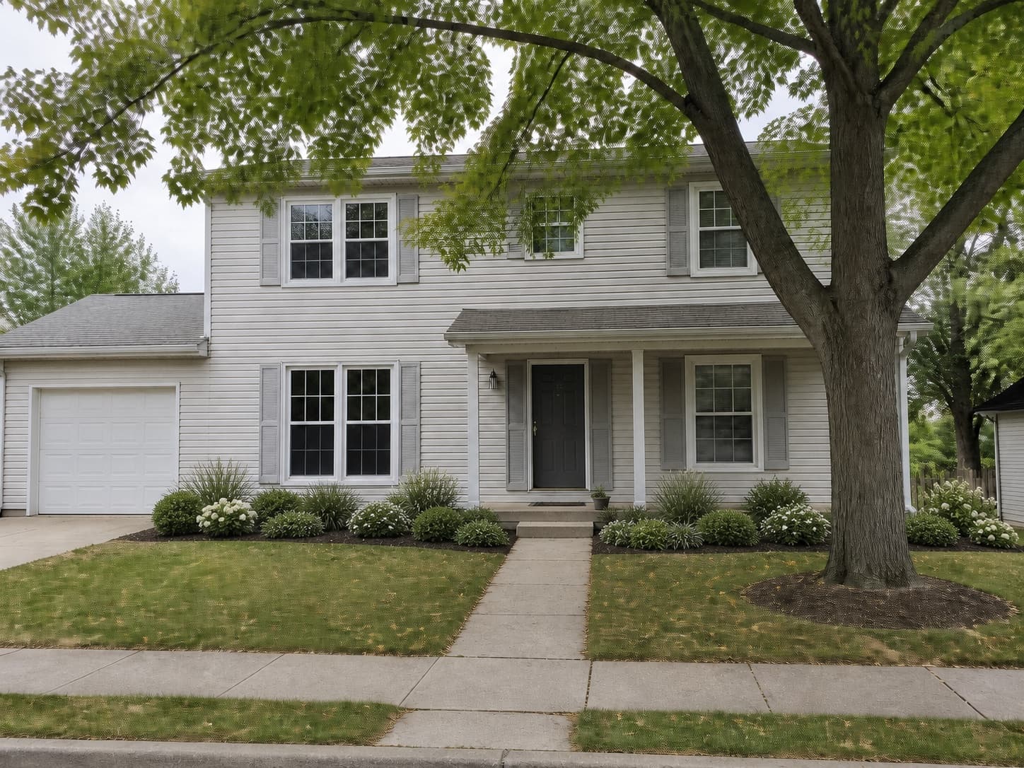 Illustrative AI landscape concept for the same light-gray suburban home with restrained layered foundation planting.