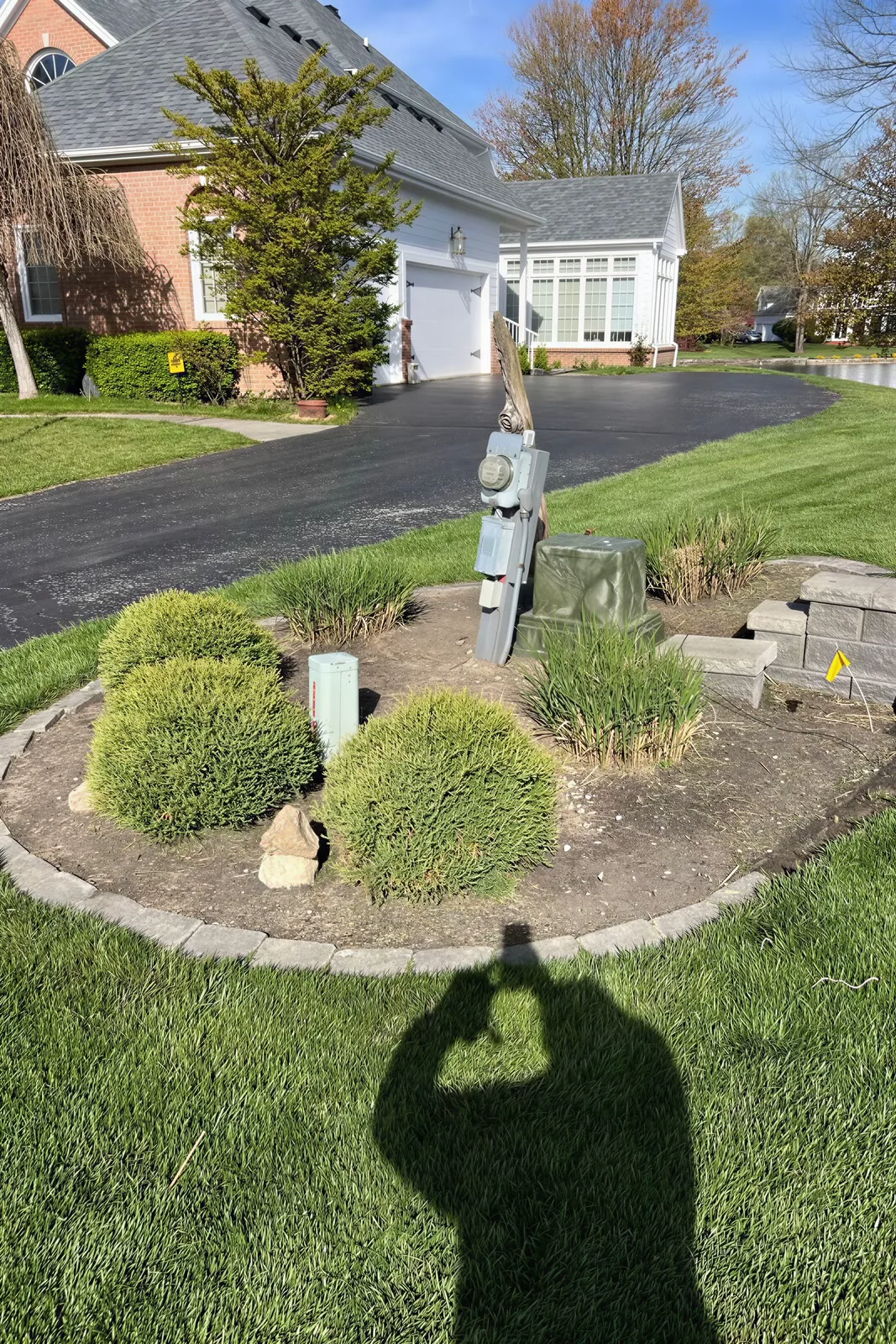 Before: the real photo of the driveway island bed