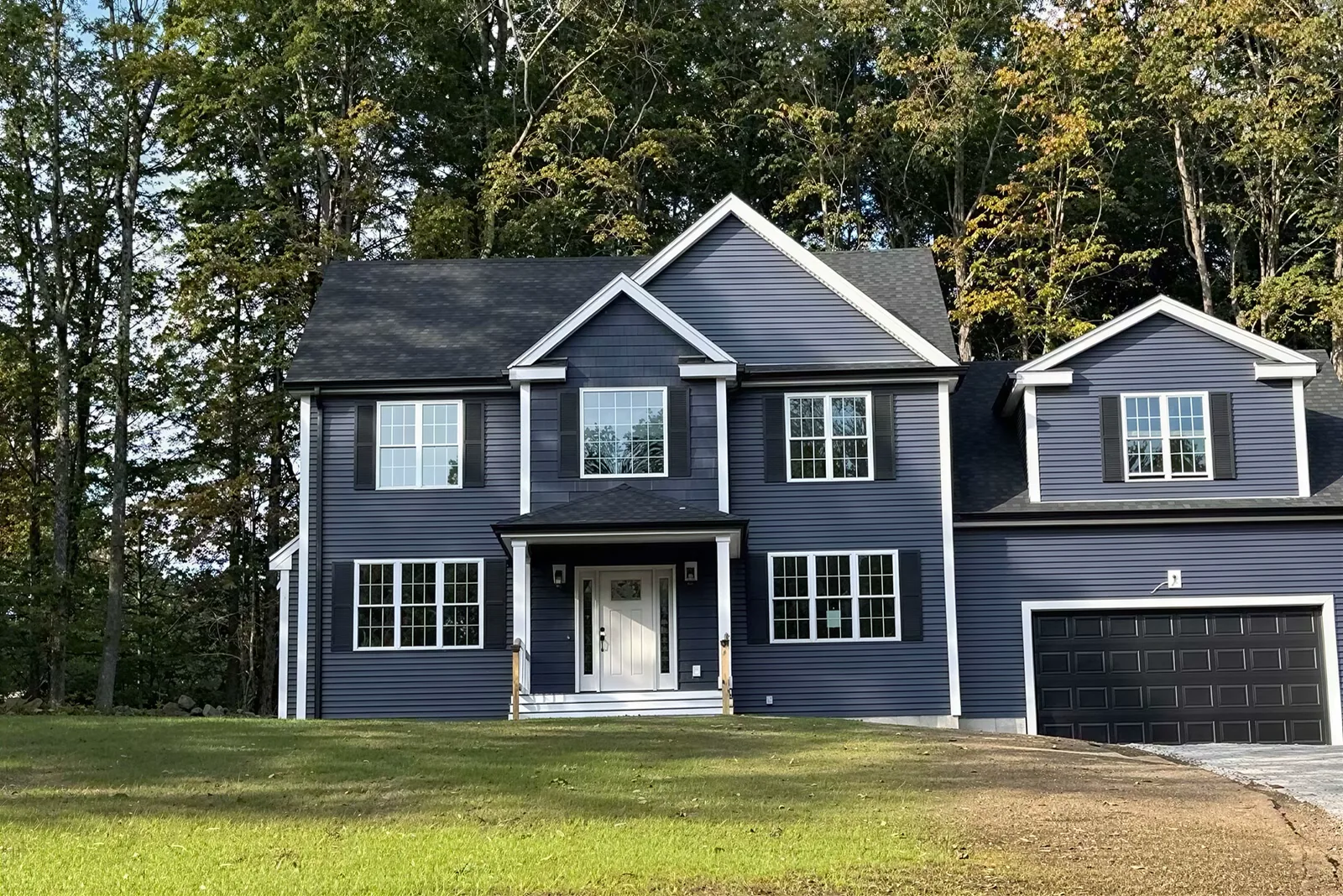Before: the real photo of the new build, bare lawn