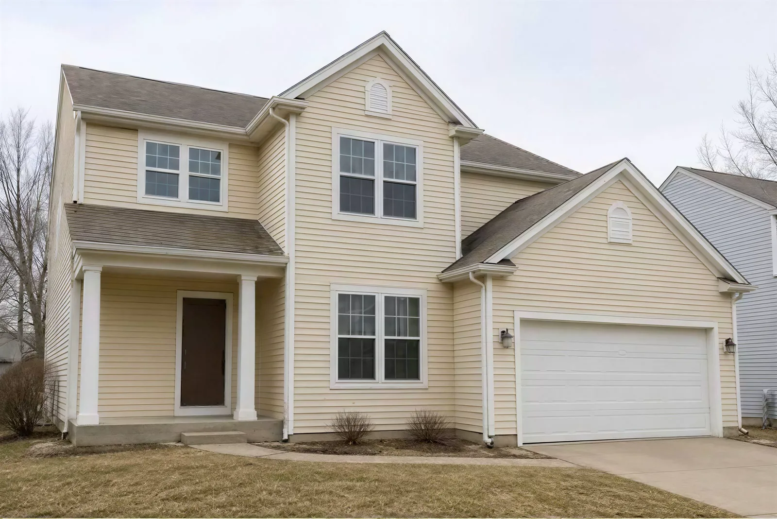 Before: the real photo of the two-story with attached garage
